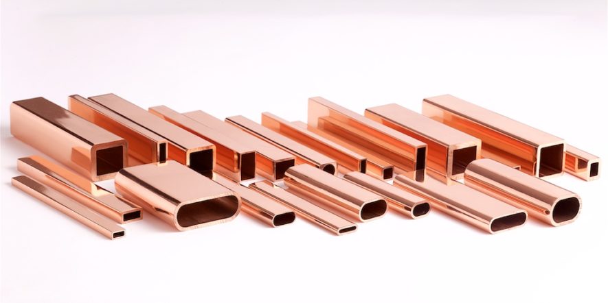 Several copper extrusions laying on white surface